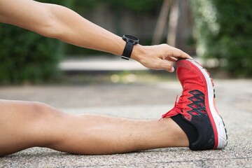 Athlete man stretching workout before practice running,or exercise to prevent muscle injury.In a Muscle inflammation concept and healthy.