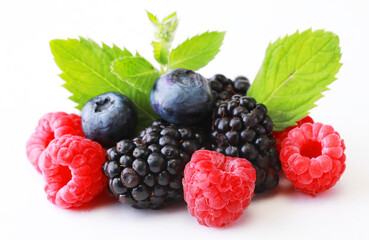 Mix berries with leaf. Various fresh berries isolated on white background. Raspberry, Blueberry, Cranberry, Blackberry and Mint leaves
