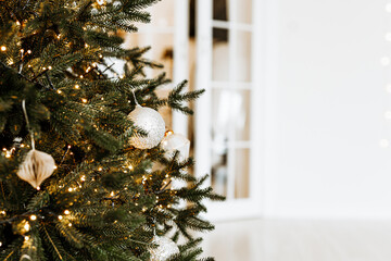 Close up of balls on christmas tree. Bokeh garlands in the background. New Year concept.