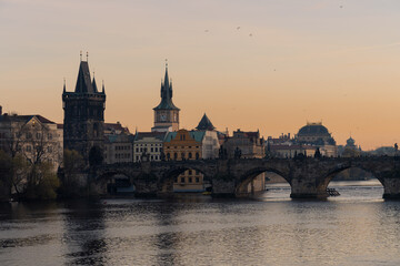 Fototapeta na wymiar Scenic view of Charles bridge over river Vltava, in Prague. Building of the National Theater in background