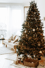 Festive interior with decorated Christmas tree and sofa