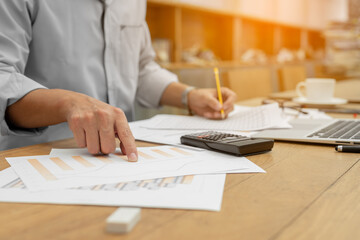 Business hands pointing for checking report chart. Businessman analyzing financial report company and calculate profit with report summary.