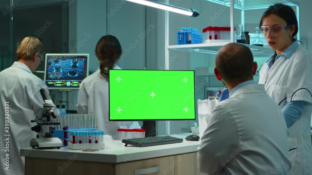 Aufkleber team of microbiologists researching using computer with green screen overtime sitting in modern equi