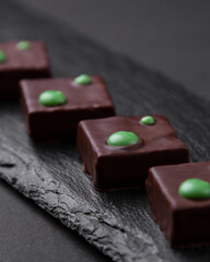 sliced square chocolates on black board