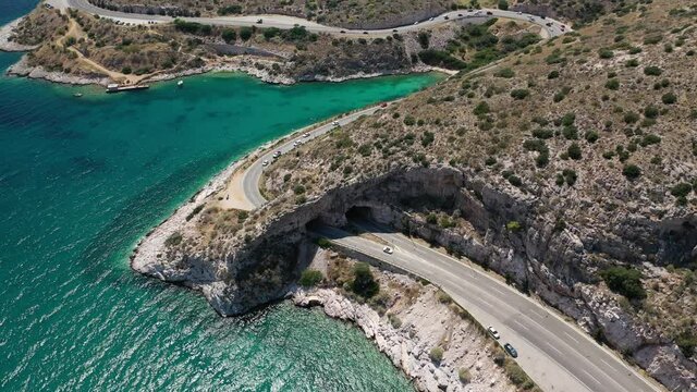 Aerial drone video of Tunnel in Athens riviera seaside road known as hole of Karamanlis or "Tripa of Karamanlis", Attica, Greece