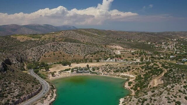 Aerial drone video of Tunnel in Athens riviera seaside road known as hole of Karamanlis or "Tripa of Karamanlis", Attica, Greece