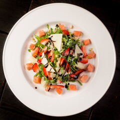 Salad with strawberries, lightly salted salmon, pomelo, parmesan 