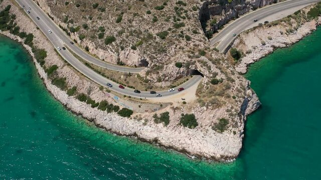 Aerial drone video of Tunnel in Athens riviera seaside road known as hole of Karamanlis or "Tripa of Karamanlis", Attica, Greece