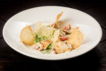 Caesar salad with chicken parmesan and croutons