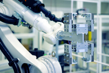 Factory 4.0 concept: View of gripper unit on handerling robot arm of automation machine.