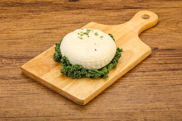 Caucasian suluguni round cheese piece