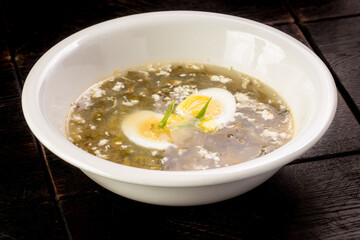 vegetable sorrel soup with egg in a plate