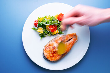 Grilled salmon with orange sauce and salad