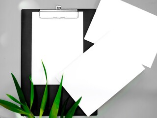 White paper mock-ups with leaves isolated on gray background, Blank portrait paper A4. brochure newspaper magazine, can use poster banners products business texture for your.