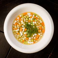 vegetable soup with carrots and zucchini garnished with dill