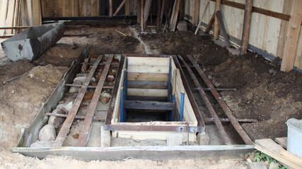 Welded metal strips and stones boulders reinforcad wooden formwork for the Foundation of the...