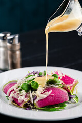 vegetable salad with radish, delicious watermelon radish salad on white dish