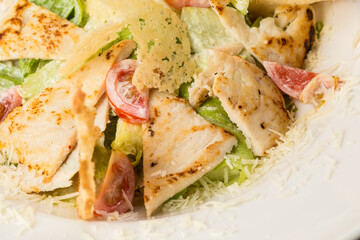 Caesar salad with chicken parmesan and croutons