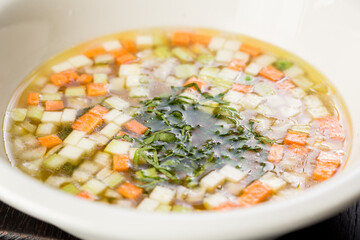 vegetable soup with carrots and zucchini garnished with dill
