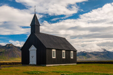 Fototapeta na wymiar Black church of Budir (Búðakirkja in icelandic) is located on the southern side of the Snaefellsness peninsula in Iceland. Picture taken in summer in a rare sunny day