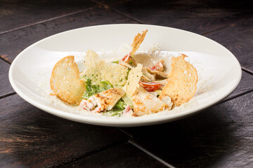 Caesar salad with chicken parmesan and croutons