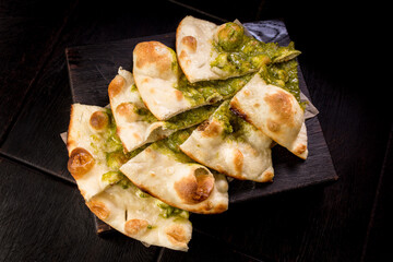 sliced delicious Italian focaccia with pesto sauce