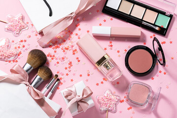 Various decorative cosmetic, perfumes, make up brushes and gift boxes and shining decorations on...