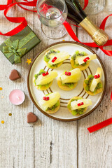 Valentines day or birthday romantic antipasto. Canapes with cheese, kiwi and pineapple. Top view flat lay. Copy space.