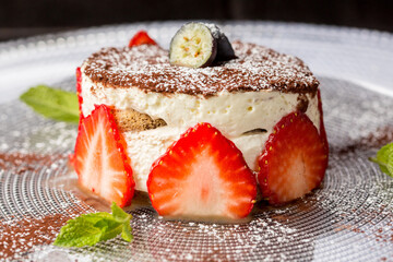 cheesecake decorated with feijoa and ripe strawberries 