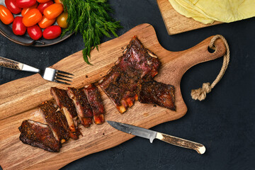 Grilled lamb breast ribs on wooden cutting board - Powered by Adobe