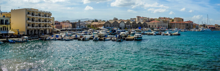 Fototapeta na wymiar A panorama view across the marina and harbour of Chania, Crete on a bright sunny day