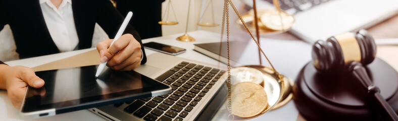 Justice and law concept.Male judge in a courtroom with the gavel, working with, computer and...
