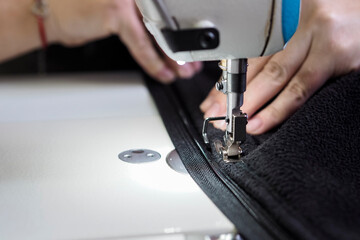 the seamstress's fingers go over the sewing material