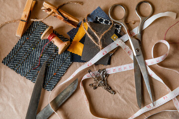 sewing tools on paper old background. scissors and thread