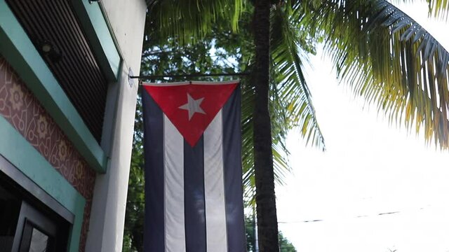 View Scanning a Cuban Flag in the Front of a Building and Then Spinning Around
