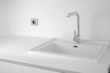 Modern bathroom interior with sink and chrome faucet.