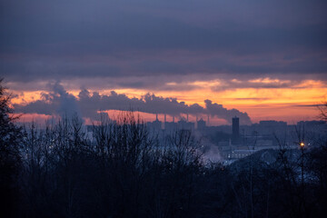 panoramic view of the city on an early frosty winter morning with chimneys on the horizon