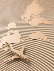 Airplane and world map made of cardboard