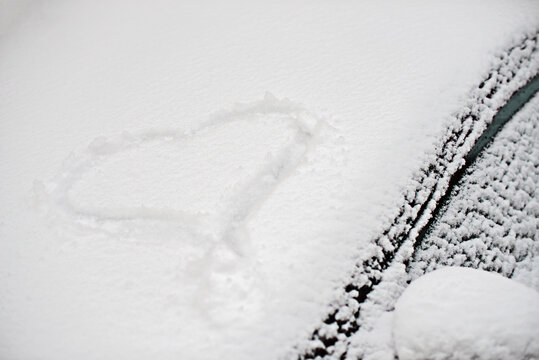 snowy heart on the windshield of a car, winter photo