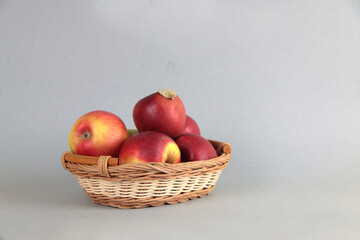 basket of red apples isolated against gray background