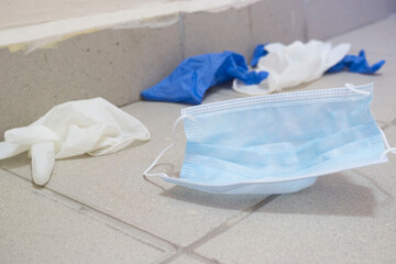 Used medical face masks and gloves in public buildings and premises. Environmental pollution concept