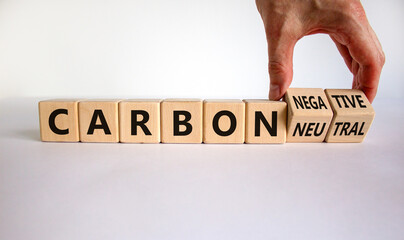 From carbon neutral to negative. Hand flips cubes and changes words 'carbon neutral' to 'carbon...