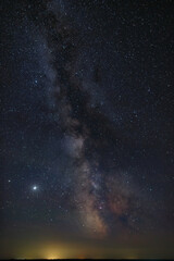 Stars in the sky at night. Bright Milky Way over the city.