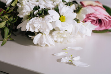 Bouquet of faded flowers on the white table