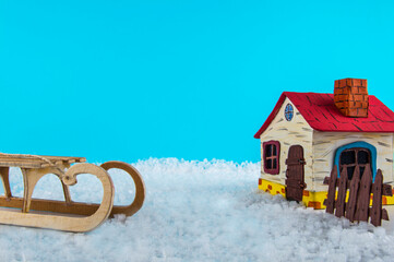 toy house and sleds on a blue background