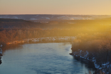 Sunset over the river. Bright clear sky.