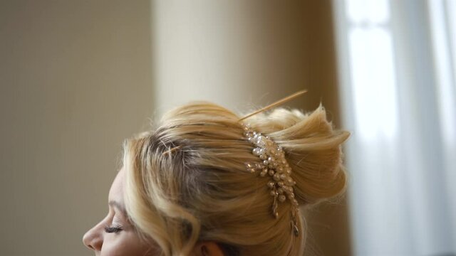 Copy space: Blonde bride getting ready for wedding in morning