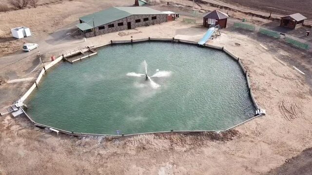 Aerial photography of an artificial pond with a fountain