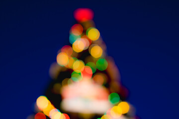 Christmas tree in blurred focus. Bokeh balls of different colors. Christmas, New Year, Christmas Eve.