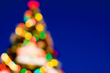 Christmas tree in blurred focus. Bokeh balls of different colors. Christmas, New Year, Christmas Eve.